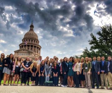 A large group of people outside of the Texas Capitol