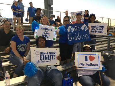 Supporters cheering on TJJD teams at the game