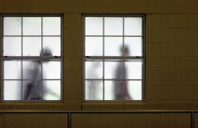 Youths walk by the windows of the dining hall on their way to lunch Thursday, Oct. 12, 2006, at the Giddings State School in Giddings, Texas. Via BRETT COOMER/HOUSTON CHRONICLE